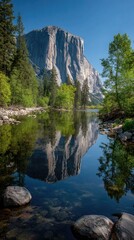 A serene landscape showcases a majestic granite peak reflected flawlessly in a tranquil river, surrounded by lush greenery and vibrant trees.