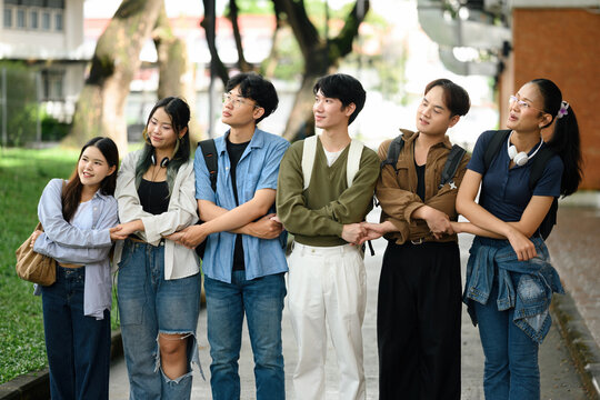 A diverse group of university students standing arm-in-arm, representing unity, inclusion, and acceptance in a supportive campus community