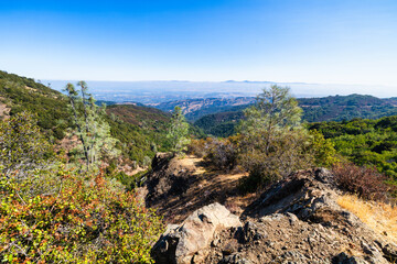 Scenic mountain landscape along trail to Mount Umunhum Cube in Sierra Azul Preserve, California,...
