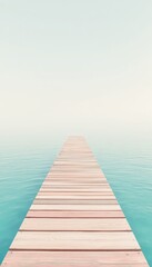 Obraz premium Wooden boardwalk stretching into calm turquoise sea under a pale sky, creating a serene minimalist scene