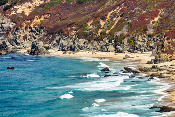 Scenic aerial view of Big Sur coastline near Point Sur Lighthouse, with turquoise Pacific waters, rugged cliffs, and rolling hills along the iconic Highway 1 in California, USA