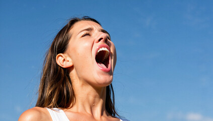 Woman Screaming Against Blue Sky