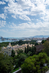 Panoramic view of a coastal city with harbor and greenery