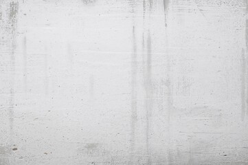 A textured wall featuring a distressed white background with an old stone or concrete appearance.