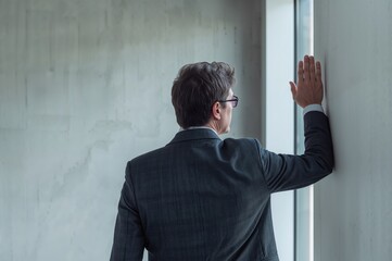 Architect Seen From Behind Raising Hand Towards Wall
