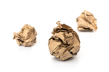 crumpled  brown kraft paper ball that is thrown on the ground is trash isolated on white background.
