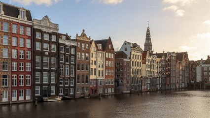Historic Canal Houses Along the Water in Amsterdam at Sunset