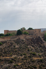 Fototapeta premium Historic castle on a hill under cloudy sky