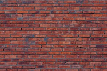 Fototapeta premium A textured brick backdrop highlighting the intricate design of natural clay bricks. Blank area on the clay brick surface for creative use.