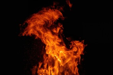 Stunning nocturnal sky illuminated by vibrant orange and red flames, creating a captivating fire that appears to set the atmosphere ablaze with its power, enhanced by a unique textured backdrop.