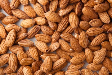 Fototapeta premium Almonds separated on a plain white backdrop, nutritious and healthy snack option
