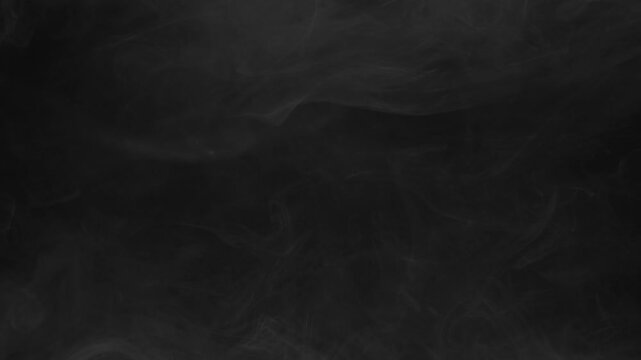 Ethereal smoke or mist drifting on black background. Seamless video footage for overlay effects in post-production and creative projects.