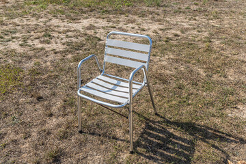 Metallic white chair on the gray background
