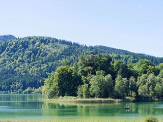 The Freudenberg peninsula along the Schlierbach stream which flows towards lake Schliersee from the water sports center opposite the beach and the spa park of the tourist town