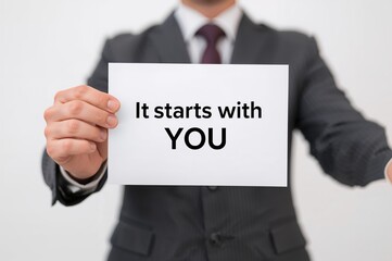 Close-up of a businessman&acirc;&euro;&trade;s hand displaying a blank sheet for custom messages or slogans starting with 'You'