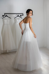 Fashion model in classic strapless wedding dress with lace-up back