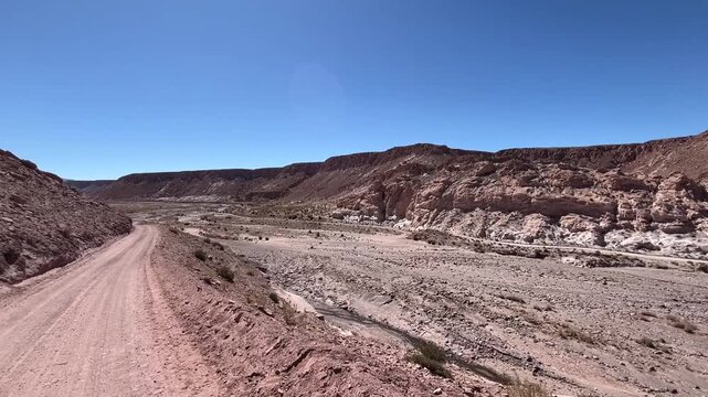Video footage driving a dirt road in spectacular landscape scenery close to  "Valle de Arcoiris"  Englisch "Rainbow Valley'' in the Atacama Desert of Chile. Variable colours of stone, rocks, mountains