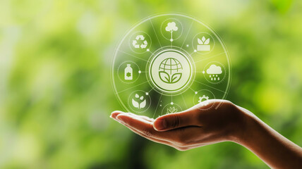 Hand holding a holographic display of environmental icons and a green globe image photo