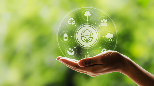 Hand holding a holographic display of environmental icons and a green globe image photo