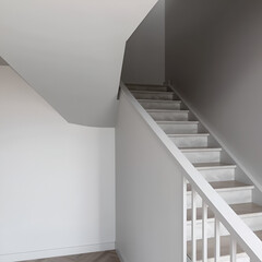 Obraz premium Gray functionalist staircase in interior, Staircase with banister in minimalist style, Detail of a modern stair, Symbol of staircase, Stair house, Modern stairway in house