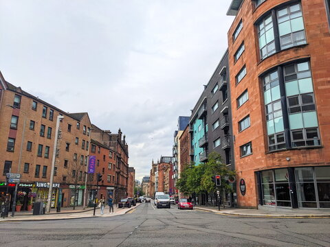 Urban streetscape of High Street in Glasgow's Merchant City with traffic and pedestrians