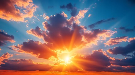 Fototapeta premium Radiant sunrise paints the sky with vibrant orange and pink clouds, casting golden sunbeams through dramatic atmospheric light.