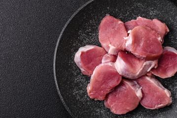 Raw pork tenderloin, sliced, is fresh meat, a source of protein. Pork tenderloin