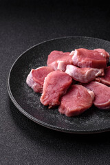Raw pork tenderloin, sliced, is fresh meat, a source of protein. Pork tenderloin