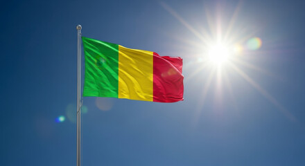 Malian Flag Waving Proudly Under Bright Sun in Blue Sky