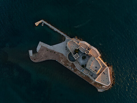 Aerial view of the imposing Bourtzi castle standing proudly against the deep blue sea, a stony sentinel guarding the harbor, Nafplion, Argolis, Greece.