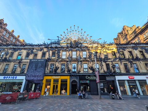 Architectural detail of Glasgow's Princes Square with its unique roof sculpture under a blue sky