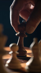 a human hand placing a chess pawn on a wooden chessboard, shallow depth of field