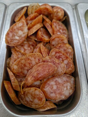 Chinese sausage in  a metal stainless steel food pan