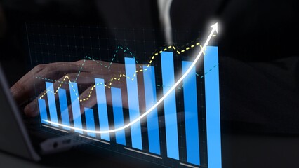 A business professional examines a digital representation of financial growth data, showcasing an upward trend in performance on a laptop screen, symbolizing success. Copula