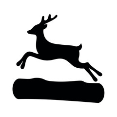Silhouette of a leaping stag jumping over a log in a dynamic pose