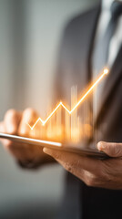 Businessman holding tablet and showing holographic graphs