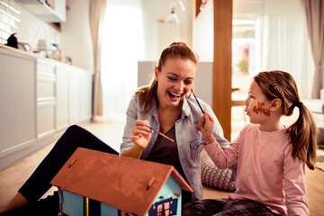 Mother and daughter painting together