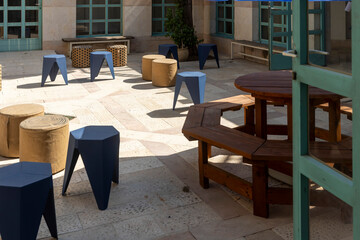 Modern Courtyard with Geometric Stools and Wooden Table