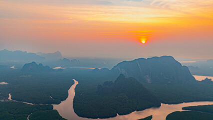 Aerial view Deltas of the river and mangroves in heart island in sweet sky at sunrise. Canals winding in the mangroves create a heart-shaped island. beautiful tropical landscape background