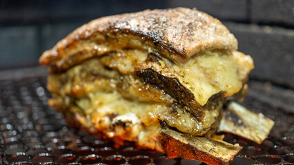 Succulent beef short ribs grilling over glowing charcoal and wood. Authentic Brazilian churrasco style, with a smoky crust. Perfect for barbecue content and food blogs.