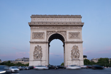 Arc de Triomphe in Paris stone archway structure stands majestically against a twilight sky, surrounded by bustling traffic, symbolizing historical significance and architectural beauty