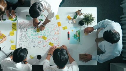 Top view of professional business team working together to brainstorm environmental idea by using...