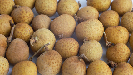 Fresh Dimocarpus longan fruit close-up isolated on white background, showcasing tropical sweetness, organic freshness, healthy snack, and exotic Asian fruit concept.
