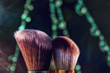 The makeup brush is shown in close-up against a beautiful backdrop