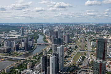 Skyline of Moscow featuring modern architecture, winding rivers, and green spaces, observed from a high vantage point showcasing the city layout.