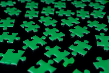 Many green puzzle pieces scattered on a dark background