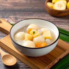Bowl of sweet soup with dumplings and fruit
