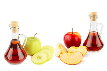 Two glass jugs with apple cider vinegar and fresh apples