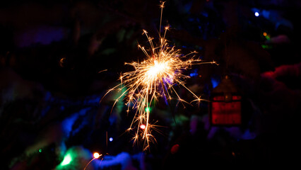 sparkler or bengal light burning on Christmas background