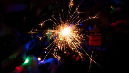 sparkler or bengal light burning on Christmas background